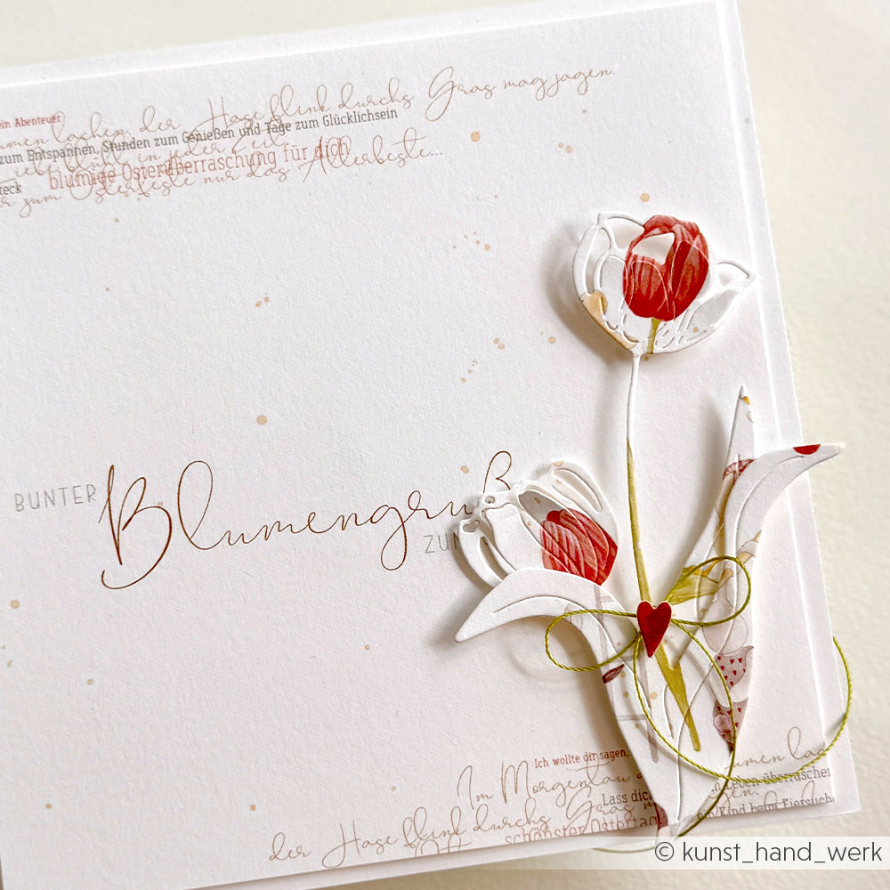 Handgemachte Grußkarte von Alexandra Renke mit roten und weißen Papiertulpen aus hochwertigem Designpapier mit elegantem kursivem Text auf weißem Hintergrund.
