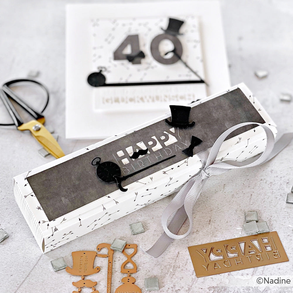 Rechteckige Geburtstagsschachtel und Karte mit den Texten "40" und "Happy Birthday" in Schwarz und Weiß, dazu Band, Schere und Stanzformen aus dem Alexandra Renke Motivstanze Gentleman Set - perfekt für kreative Stanzsysteme.