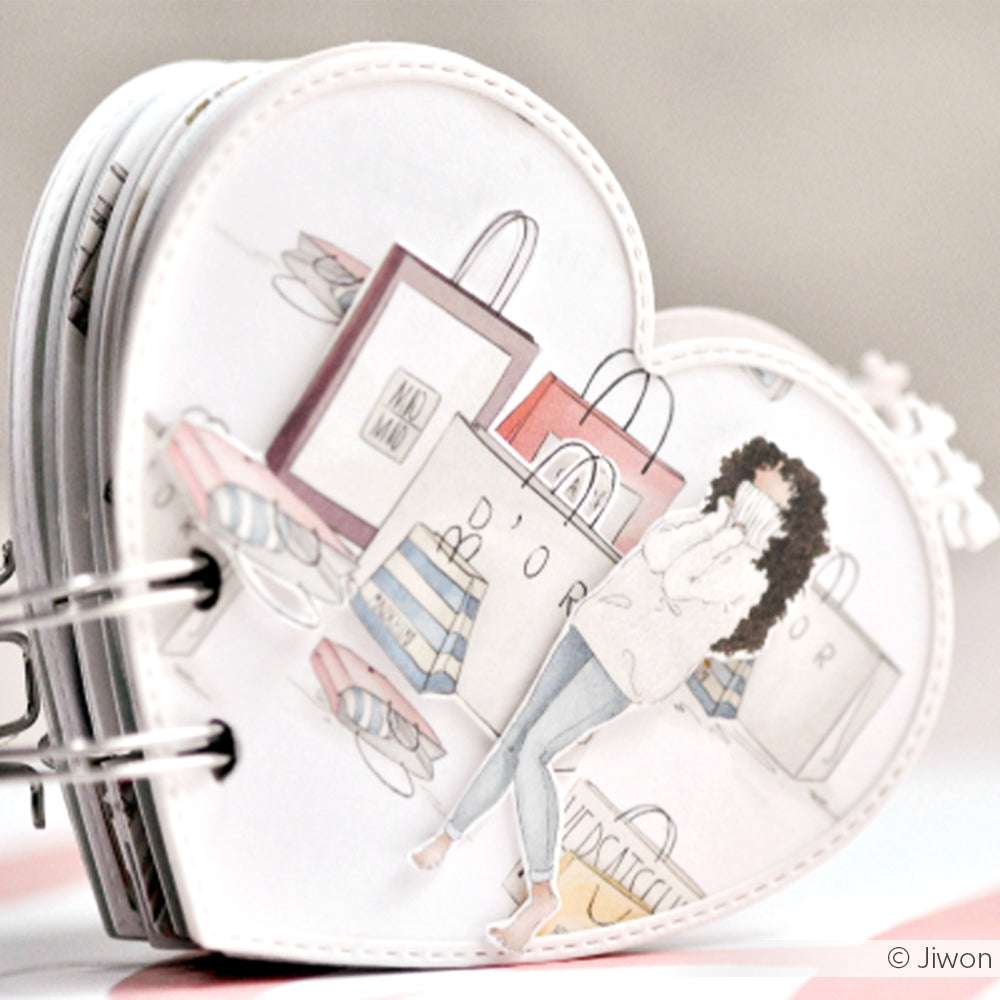 Ein herzförmiges Notizbuch von Alexandra Renke mit einer modischen Illustration einer Frau mit Einkaufstüten - ideal für Papierprojekte oder in Kombination mit Grußkarten zum kreativen Verschenken.