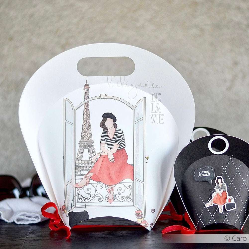 Die Geschenktaschen von Alexandra Renke zeigen illustrierte Frauen, kräftige rote Akzente und ein Eiffelturm-Motiv. Sie eignen sich perfekt zum Buchbinden oder für Papierprojekte und sind aus hochwertigem Designpapier mit einzigartigen Motiven gefertigt.