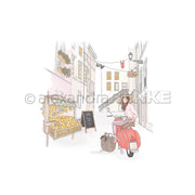 Eine Frau auf einem roten Motorroller fährt an einem Zitronenstand und einem Alexandra-Renke-Laden in einer malerischen europäischen Straße mit hängender Wäsche vorbei.