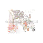 Eine Person genießt Gelato unter rosafarbenen Blüten in einer charmanten Straße, vorbei an einer Buchbinderei, in der Alexandra Renkes farbenfrohes Designpapier für inspirierende Papierprojekte ausgestellt ist.