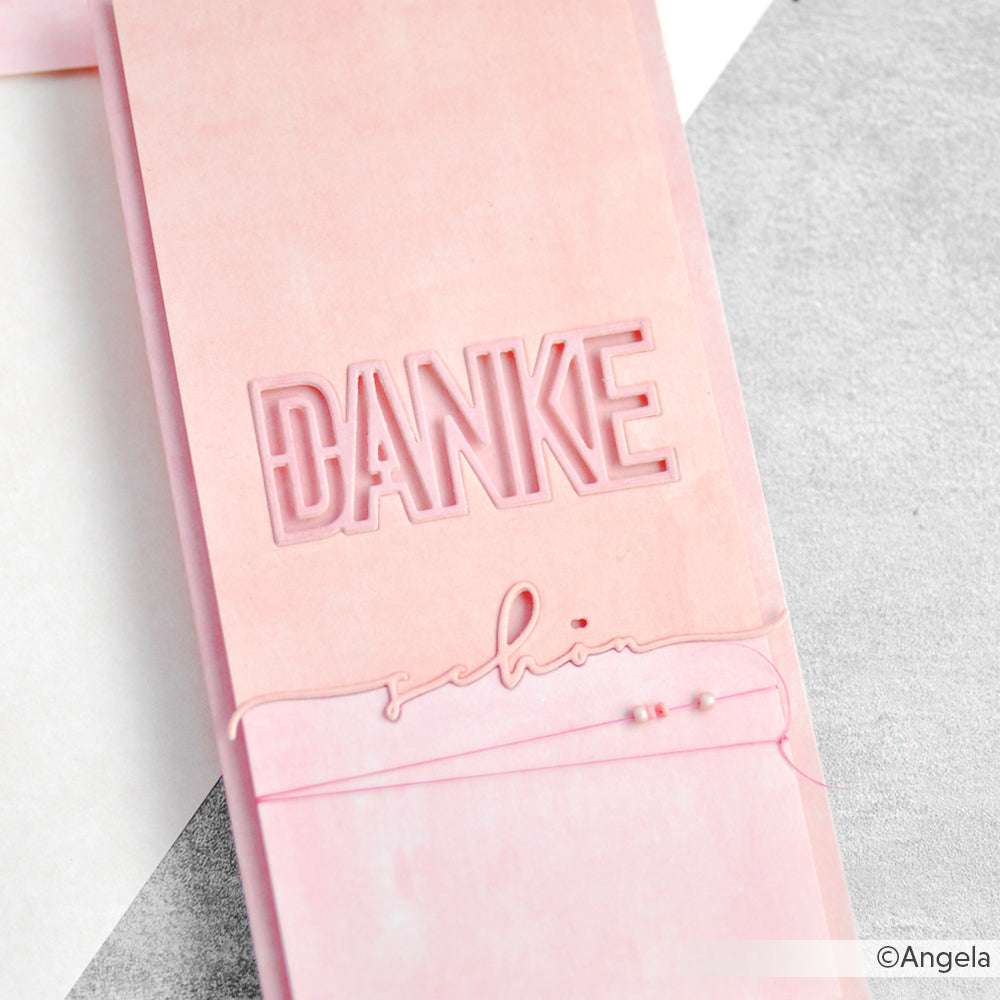 Rosafarbene Karte mit ausgeschnittenem "DANKE" und kursivem "schön", verziert mit rosa Kordel und Perlen - eine charmante Kreation von Alexandra Renke, die mit hochwertigem Designpapier hergestellt wurde und einen einzigartigen Touch hat.
