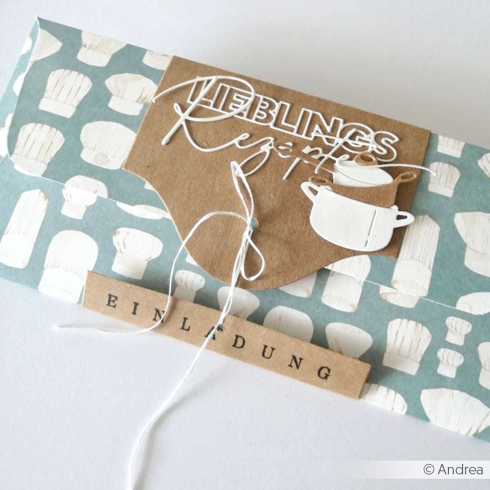 Geschenkumschlag von Alexandra Renke, gestaltet mit kochendem Designpapier, Kordelverschluss und dem Schriftzug Lieblingsrezepte & Einladung-perfekt für Papierprojekte oder Buchbinderei.