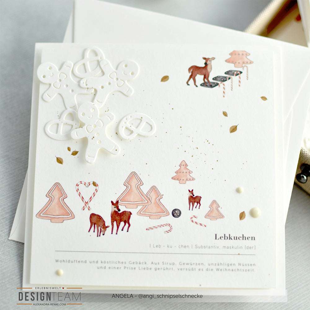 Weiße Weihnachtskarte von Alexandra Renke aus Designpapier mit Lebkuchenmännchen, Rehen, Bäumen, Zuckerstangen und Goldspritzern - ideal für festliche Grußkarten oder Papierprojekte.