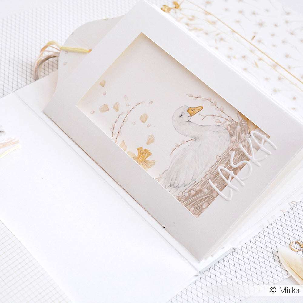 Eine handgefertigte Karte von Alexandra Renke auf hochwertigem Designpapier, die einen Schwan und "LASKA" auf Weiß zeigt. Ideal für Papierprojekte oder Buchbinderei-Fans.