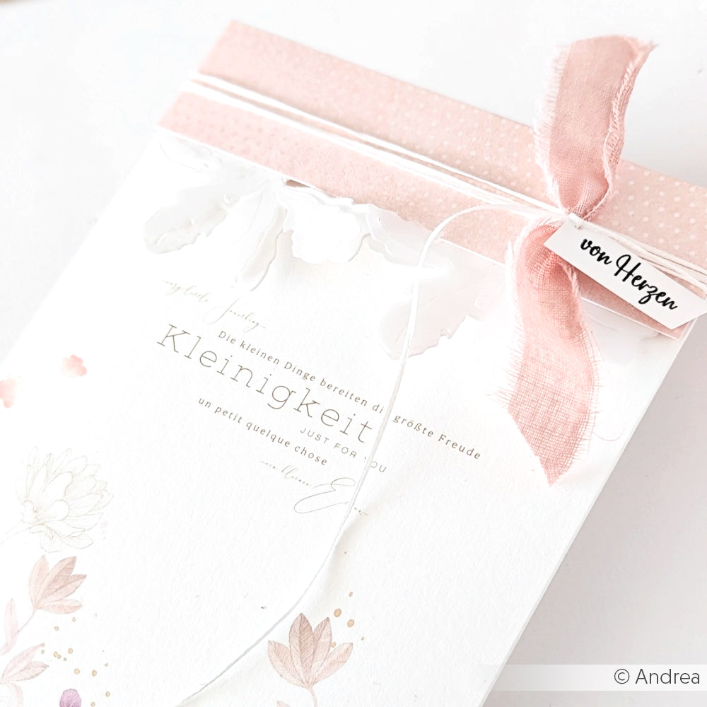 Eine zarte Grußkarte von Alexandra Renke mit floralem Designpapier, einer rosa Schleife und einem Anhänger mit der Aufschrift "von Herzen".