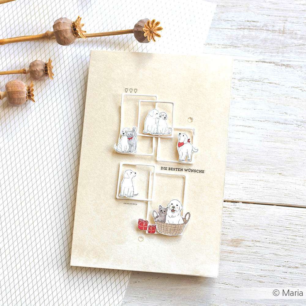 Eine bezaubernde Grußkarte von Alexandra Renke zeigt eine Hundefamilie mit niedlichen Welpen in Schachteln und einem Korb, mit roten Herzen und Geschenken - eine ideale Inspiration für Designpapier oder andere Papierprojekte.