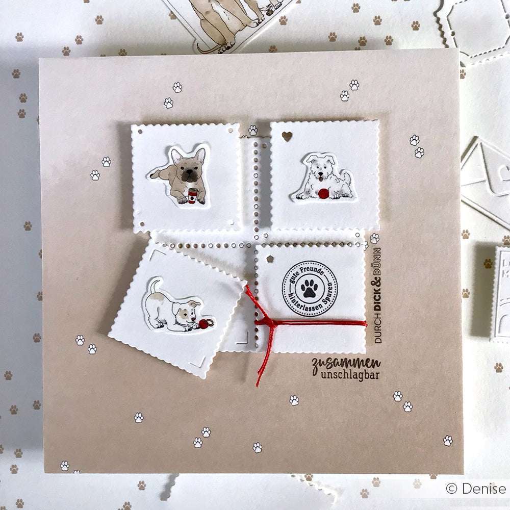 Vier quadratische Stempel von Alexandra Renke zeigen verspielte Welpen und rote Bälle auf einem cremefarbenen Hintergrund mit Pfotenabdruck und roter Schnur - das perfekte Designpapier für Grußkarten oder kreative Papierprojekte.