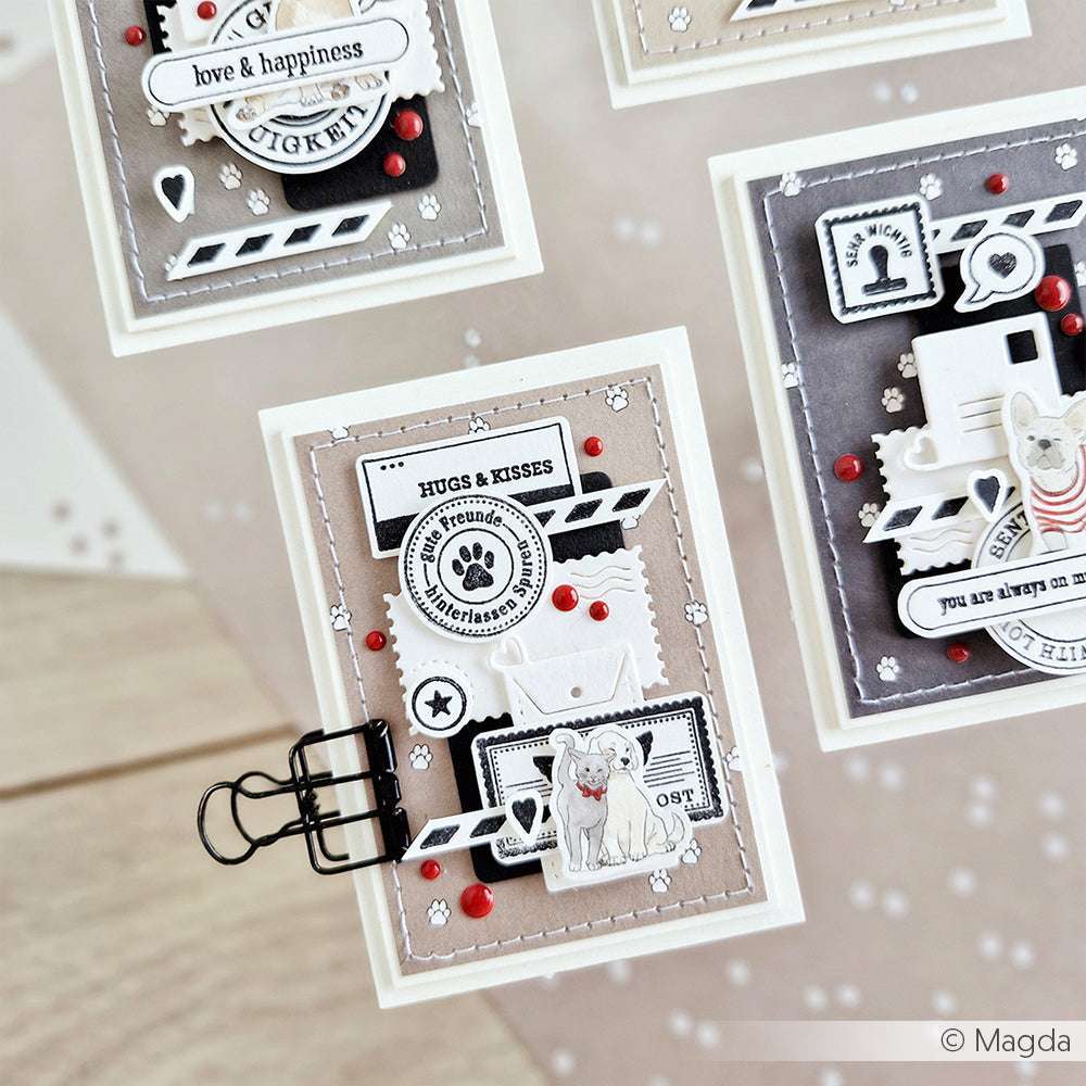 Handgefertigte Grußkarten von Alexandra Renke mit Hundeaufklebern, Umschlägen, Stempeln und roten Verzierungen auf einer hellen Oberfläche - gefertigt aus hochwertigem Designpapier für Papierprojekte und einer einzigartigen Note.