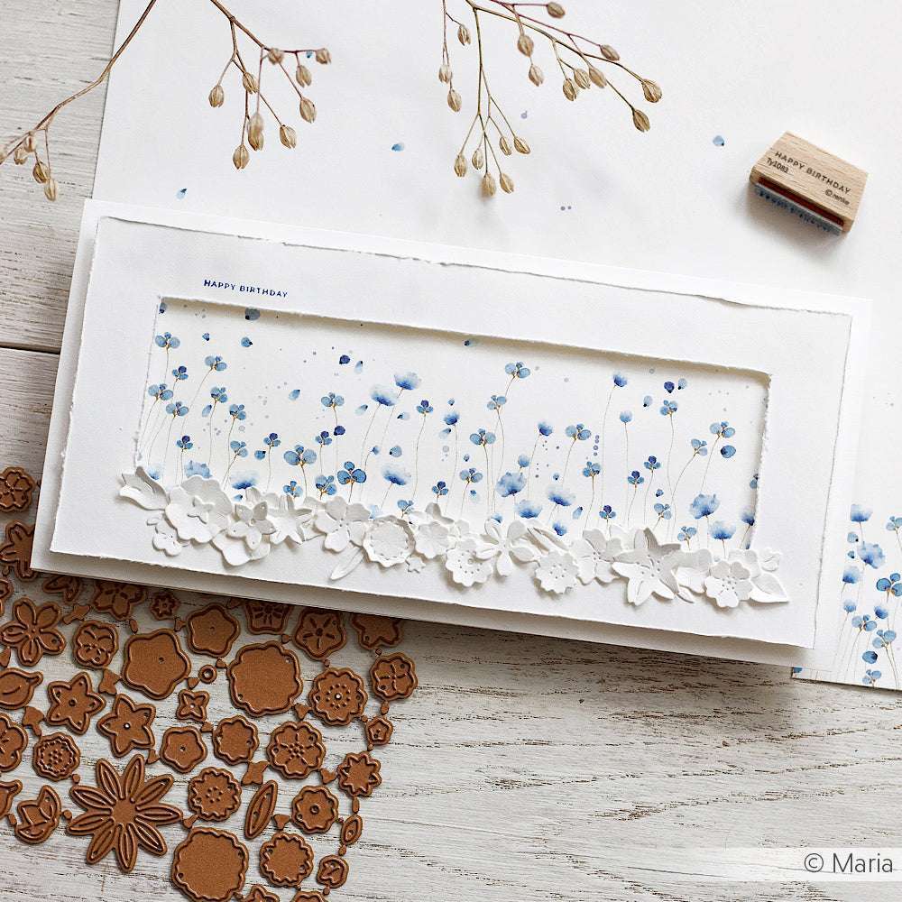 Handgemachte Geburtstagskarte von Alexandra Renke mit blauen Blüten, floralen Stanzungen und Blumenstempeln auf hochwertigem Designpapier. Ideal für einzigartige Papierprojekte und besondere Feierlichkeiten.