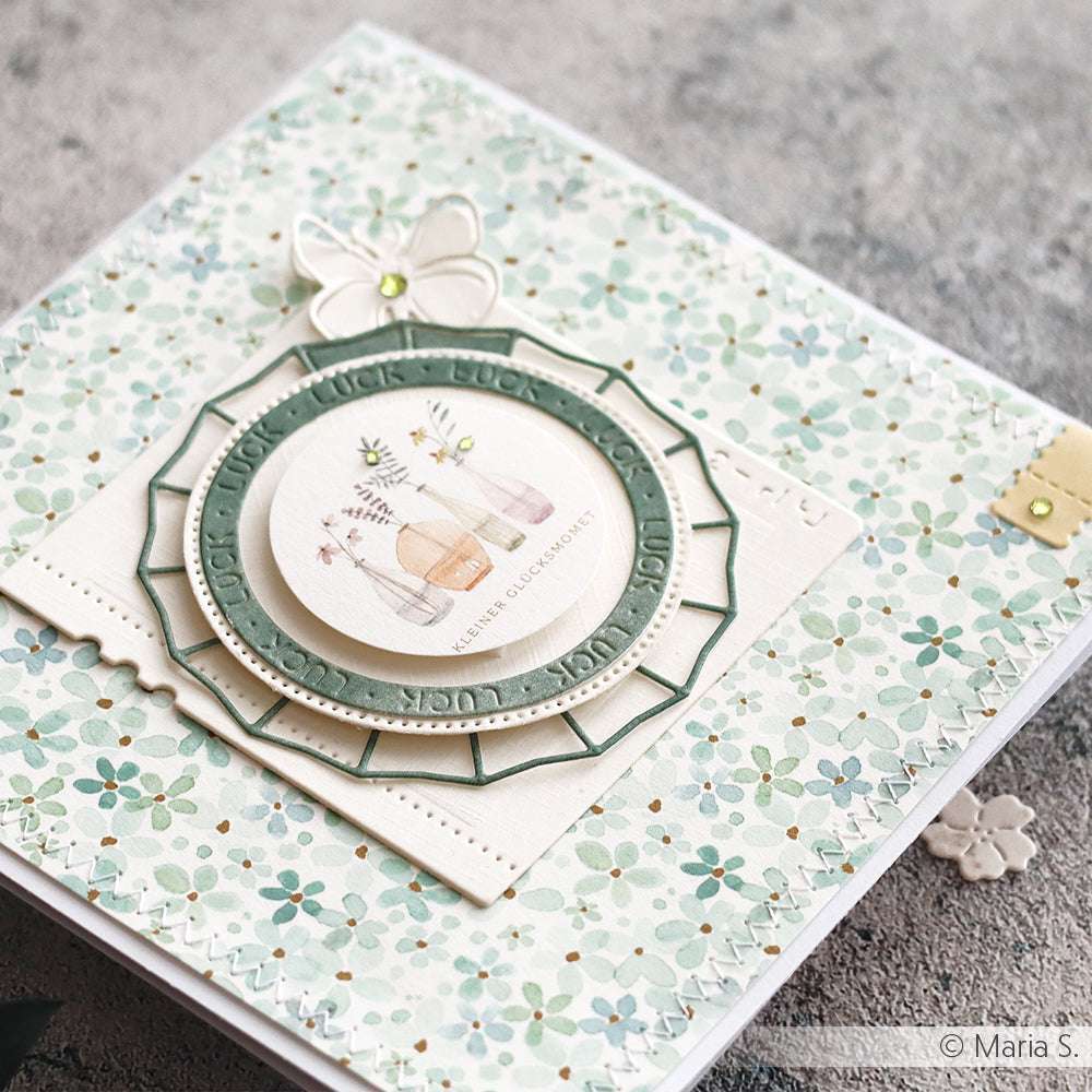 Handgemachte Blumenkarte von Alexandra Renke mit Blütenmuster türkis-mint Designpapier, geschichteten Kreisen, Flaschen-Illustration und einem Schmetterling als Verzierung - ideal für Ihre nächsten Papierprojekte.