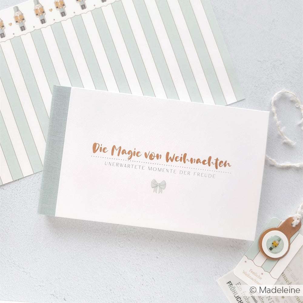 Ein deutsches Weihnachtsbuch von Alexandra Renke mit pastellfarbenen Dekorationen und Designpapier-Akzenten, mit "Die Magie von Weihnachten" auf dem Cover.
