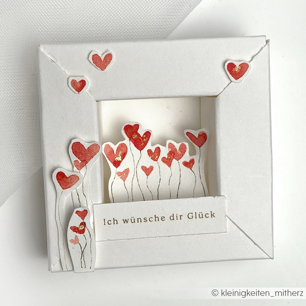 Weiße Grußkarten von Alexandra Renke mit roten Herzen und dem deutschen Text "Ich wünsche dir Glück" im Pop-up-Frame-Stil - ideal für Papierprojekte oder als kreatives Designpapier.