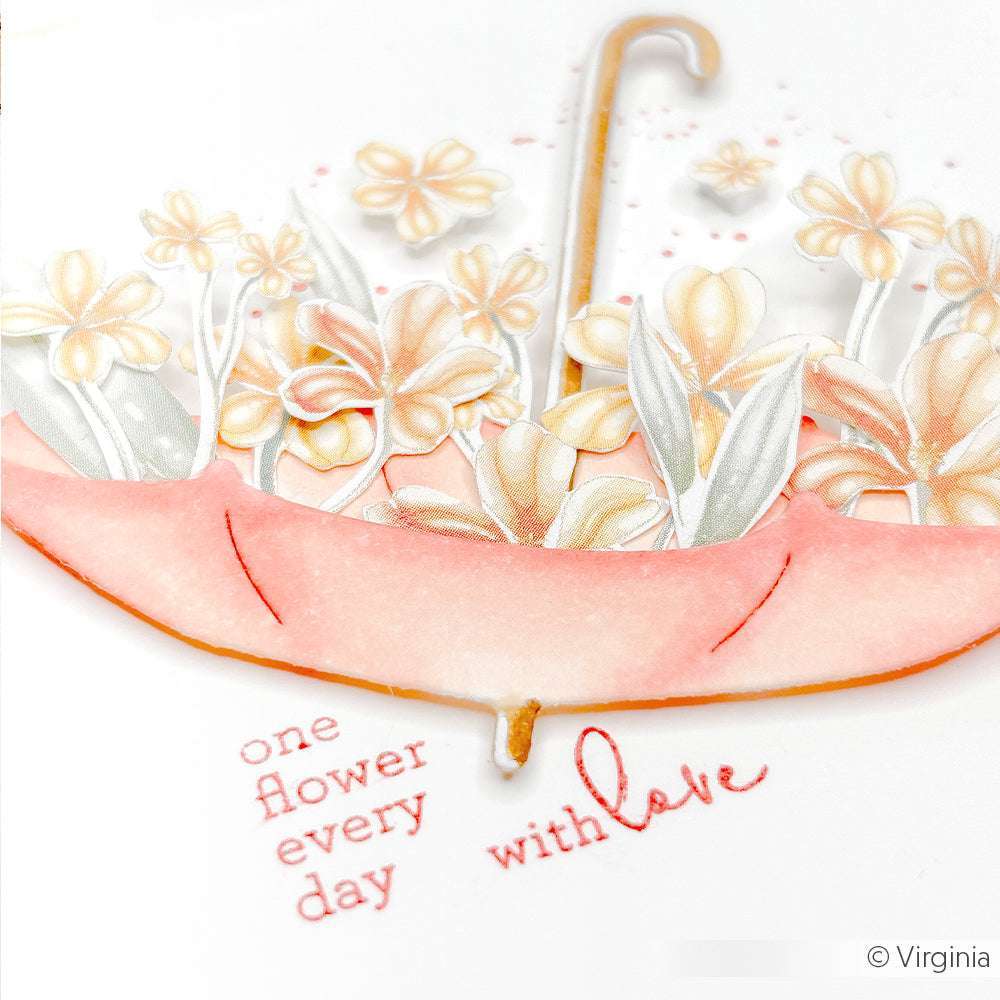 Ein rosafarbener Regenschirm von Alexandra Renke, verziert mit pastellfarbenen Blumen wie Tulpenwirbel und "jeden Tag eine Blume mit Liebe" darunter - ein charmanter Akzent für Ihre Papierprojekte oder um Ihr Lieblingsdesignpapier aufzuwerten.