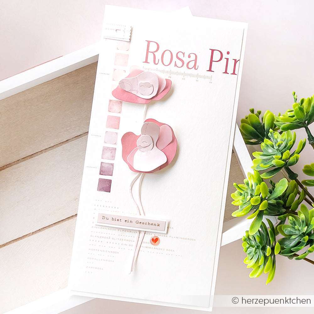 Eine handgefertigte Karte von Alexandra Renke mit Designpapier, rosa Papierblumen, Farbmustern und den Worten Rosa Pink & Du bist ein Geschenk - perfekt für kreative Blumenakzente und einzigartige Papierprojekte.