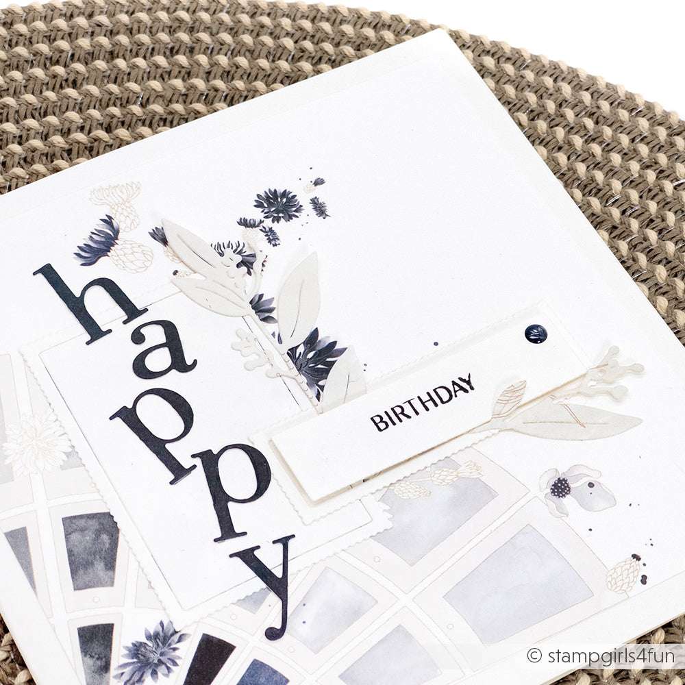 Eine handgefertigte Karte von Alexandra Renke mit "happy" in fetten Buchstaben und einem "BIRTHDAY"-Anhänger, hergestellt auf strukturiertem Designpapier.