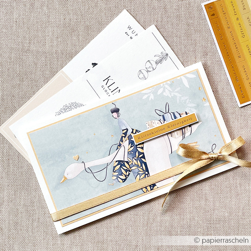 Elegante Grußkarte von Alexandra Renke mit einer illustrierten Frau auf einer Gans, goldenen Bandakzenten und Hintergrundkarten - eine perfekte Inspiration für Papierprojekte oder zum Verschenken mit Ihrem Lieblingsdesignpapier.