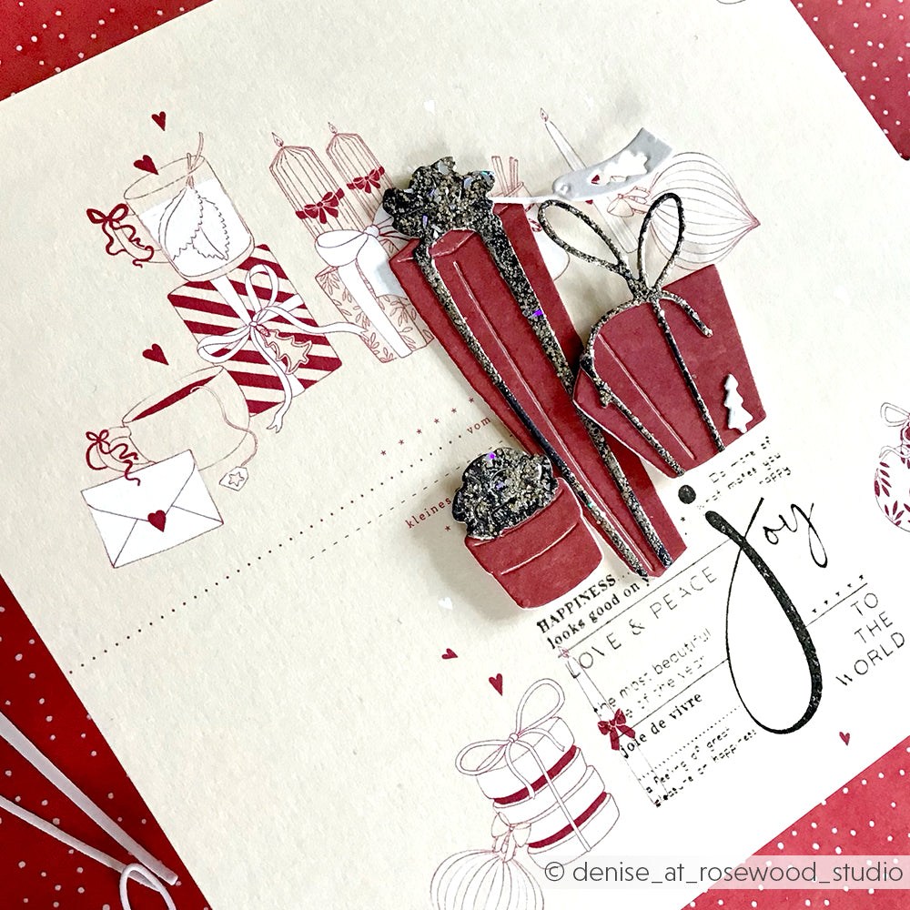 Handgemachte Weihnachtskarte von Alexandra Renke, erstellt mit Designpapier. Mit roten und weißen Papiergeschenken, Herzen und dem Text "Joy to the world" auf einem cremefarbenen Hintergrund - perfekt für festliche Projekte.