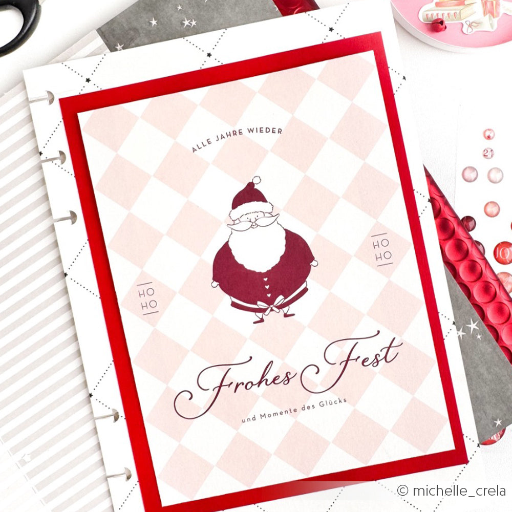 Eine weihnachtliche Karte von Alexandra Renke aus hochwertigem Designpapier mit einem fröhlichen Weihnachtsmann und dem Text "Frohes Fest" auf rot umrandetem Hintergrund - ideal für Ihre Papierprojekte.