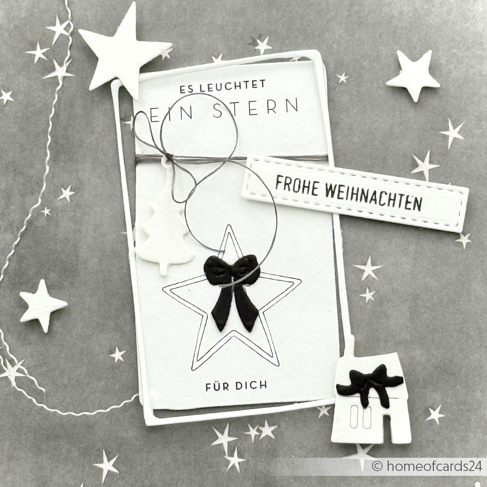 Schwarz-weiße Weihnachtskarte aus Alexandra Renke Designpapier Weihnachtsmagie mit Sternen, Schleife, Baum und dem Anhänger "Frohe Weihnachten" - ideal für festliche Grußkarten und Papierprojekte.