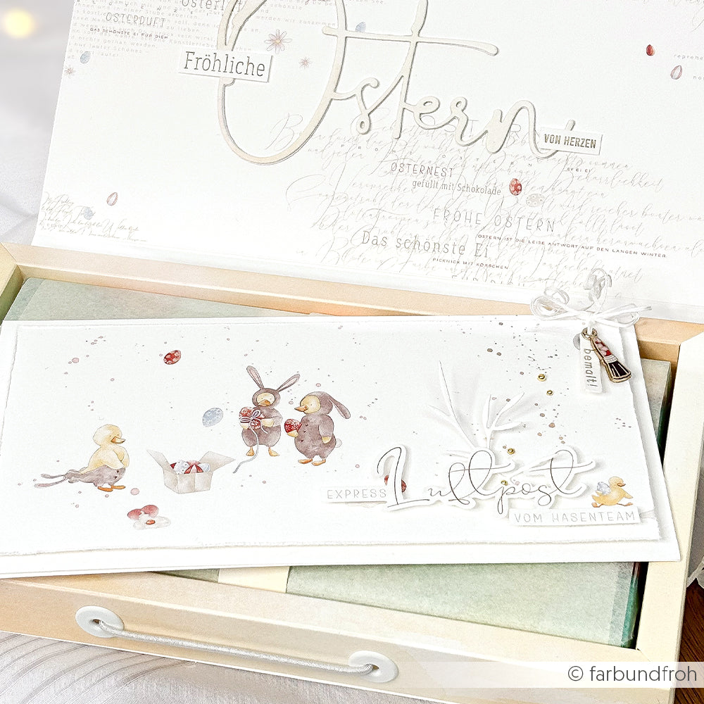 Weiße Osterkarte von Alexandra Renke mit niedlich illustrierten Tieren, zarter Schrift und festlichem Dekor - gestaltet mit Buchbinderei-Techniken und charmanten Akzenten aus Designpapier Luftpost.