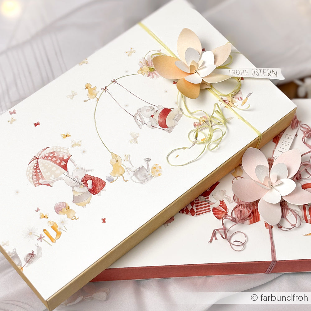 Zwei dekorierte Geschenkboxen von Alexandra Renke mit pastellfarbenen Blumen und niedlichen Tieren, beschriftet mit "Frohe Ostern", aus ausgewähltem Designerpapier - perfekt für Ihre Osterfreude!.
