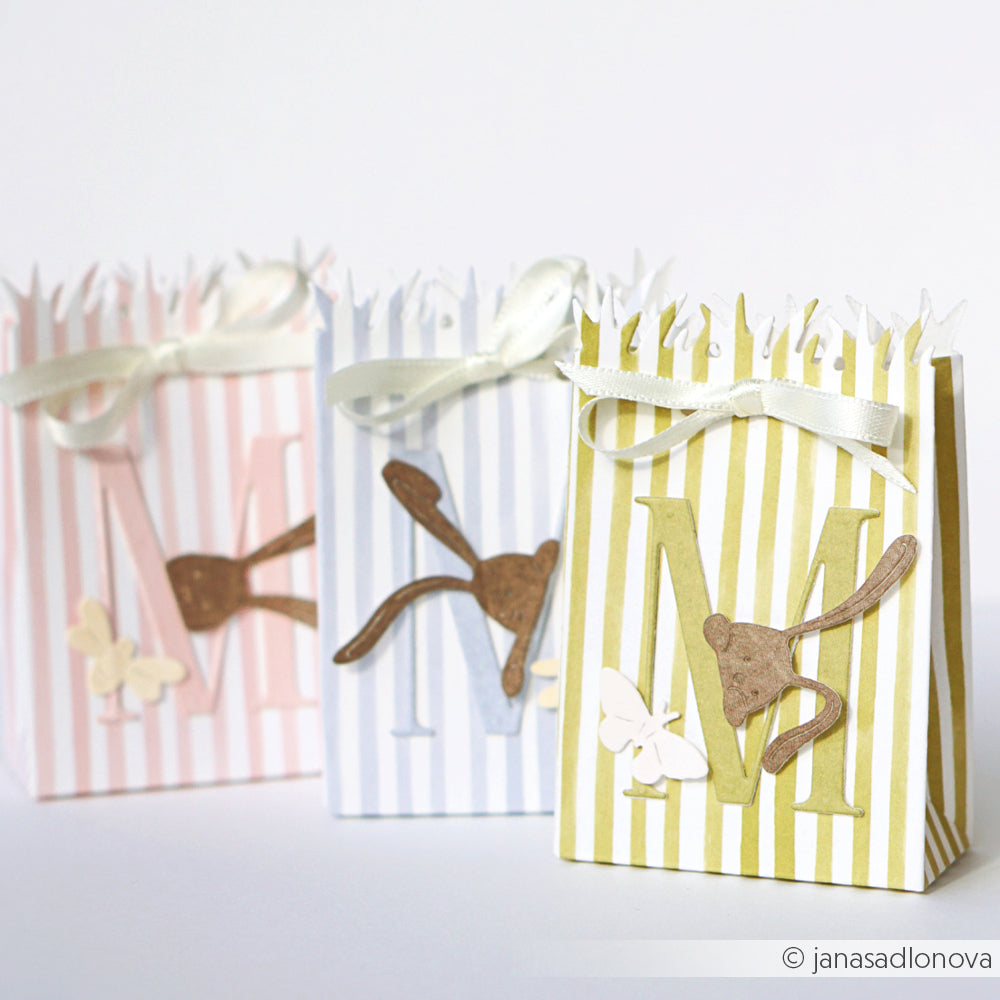 Drei gestreifte Geschenktüten von Alexandra Renke aus Chartreuse gestreiftem Papier mit Fransen, Bändern und pastellfarbenen Tier- oder Schmetterlingsakzenten - ideal für kreative Papierprojekte oder stilvolle Grußkarten.