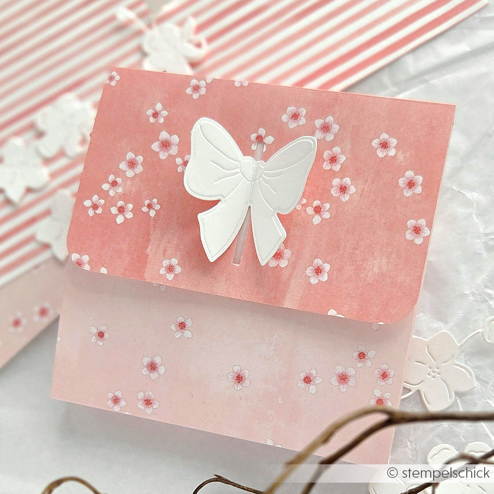 Rosa Blumenkarte von Alexandra Renke mit einem großen weißen Schmetterling auf der Vorderseite, gestaltet mit Designpapier und Kirschblütenmotiven auf gestreiftem und floralem Hintergrund - ideal für Ihre Papierprojekte.
