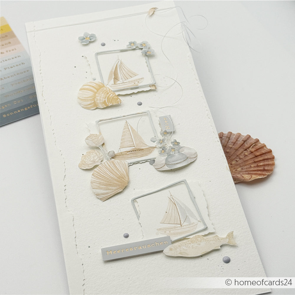 Handgefertigte Karte von Alexandra Renke mit Segelbooten, Muscheln, einem Wal und Blumen in zarten Pastellfarben auf Weiß - ideal für Papierprojekte oder als Inspiration für Floraler Schiffsrapport Designpapier.