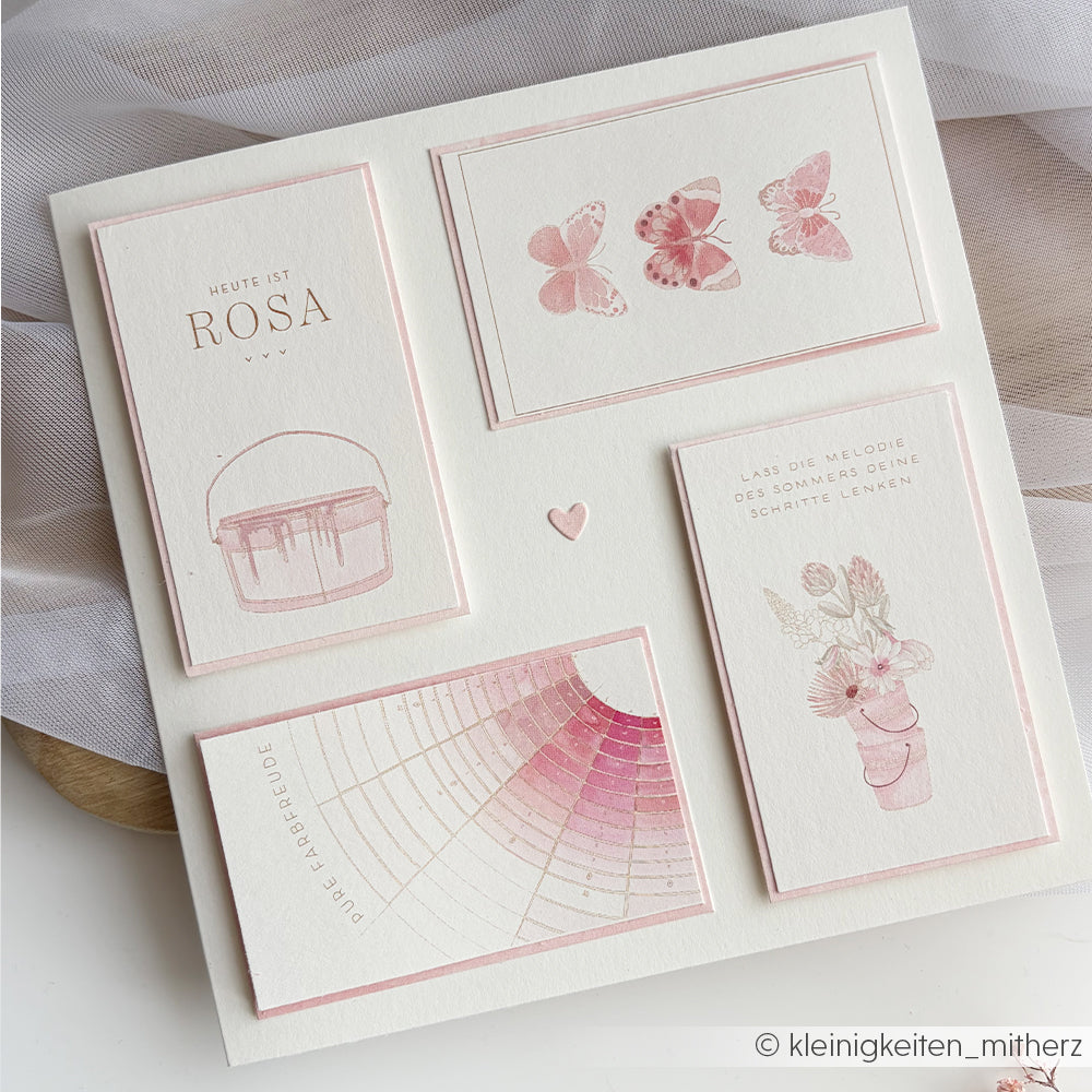 Eine minimale Collage aus rosafarbenen Karten von Alexandra Renke, mit Schmetterlingen, Blumen, Aquarellmalerei und deutschem Text auf weißem Papier - ideal für Papierprojekte oder als Floraler Kärtchenbogen Rosa Designpapier.