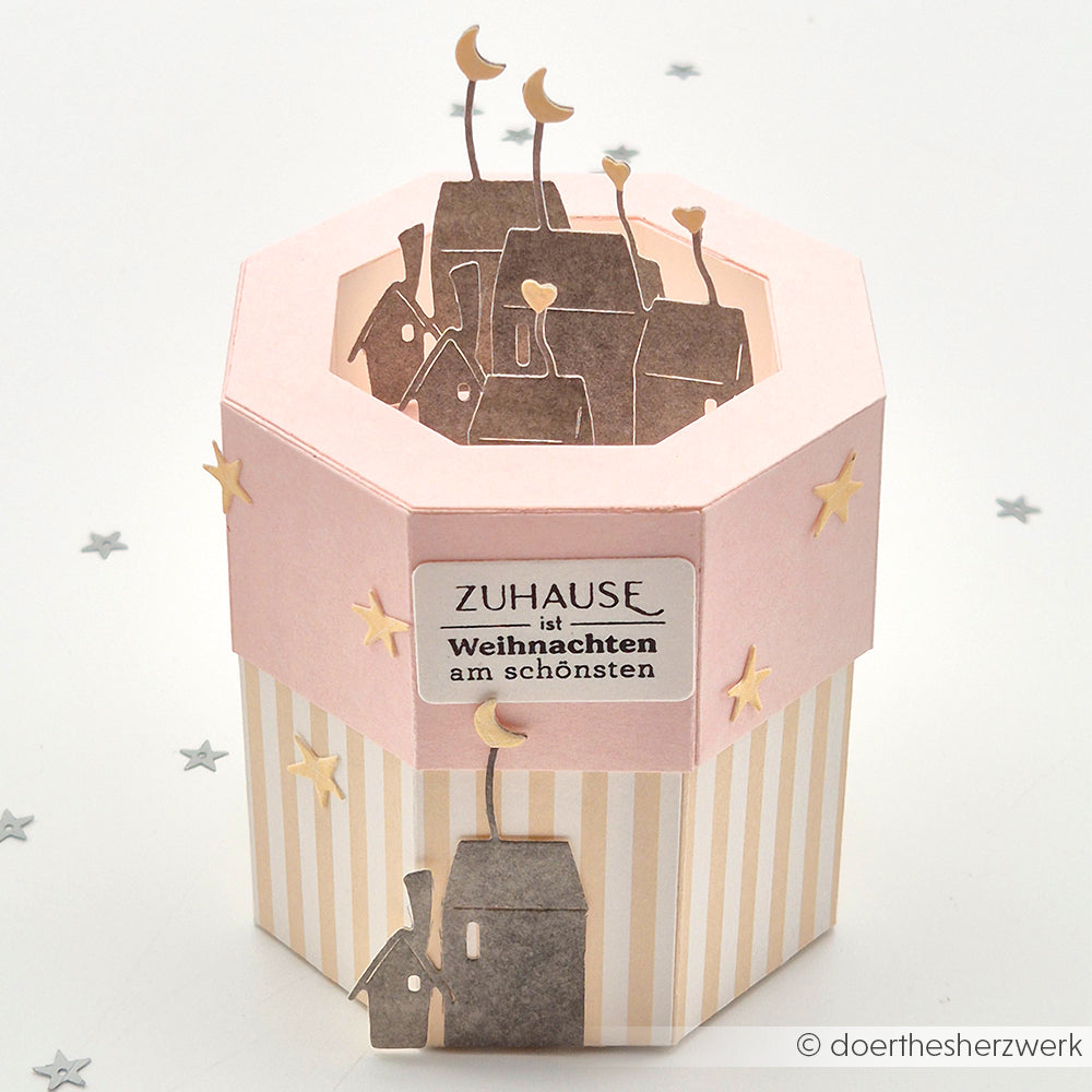 Sechseckige rosa-beige Schachtel von Alexandra Renke mit einer Dorfszene, Sternen und einem Weihnachtsgruß - gefertigt mit Deep Edge Motivstanzen für perfekte Details; ideal als festliches Geschenk für PAPPcut®ies oder Motivstanze Achteckbox.