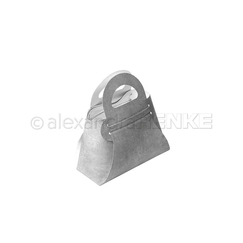 Eine graue Geschenkbox in Form einer Handtasche mit Henkel, hergestellt mit Alexandra Renke Designpapieren und Motivstanze Steck-Tasche Stanzsysteme, auf weißem Hintergrund.