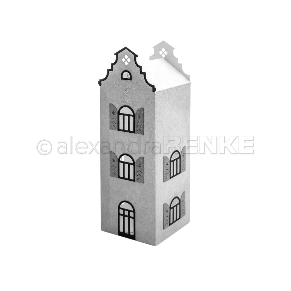 Ein Papiermodell eines hohen, schmalen Hauses mit Bogenfenstern und einer verzierten Dachfassade, gefertigt mit den „Motivstanze Häuserbox DieCut Systeme“ und veredelt mit eleganten Designpapieren.