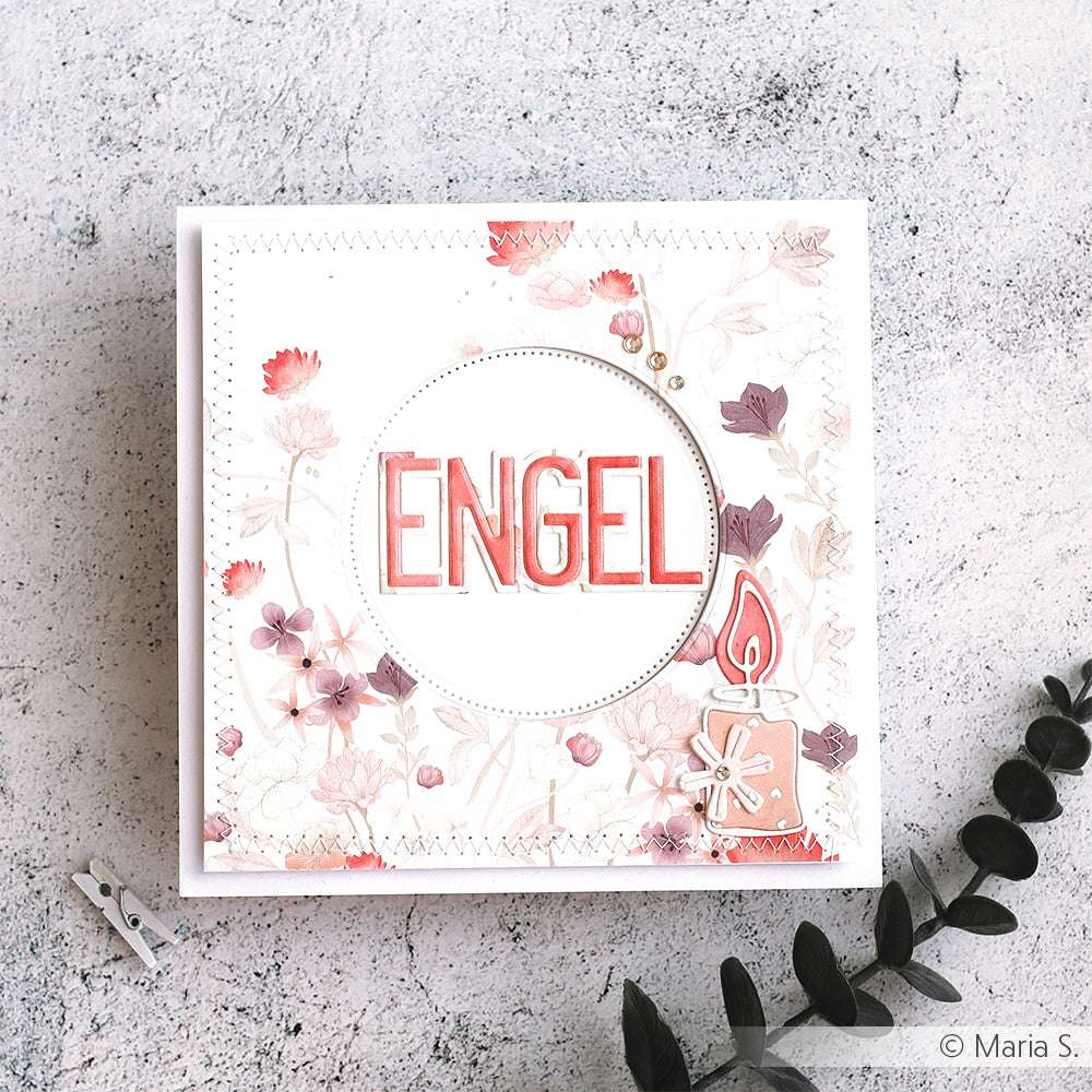 Quadratische Karte mit dem Text "ENGEL", floralen Motiven, einer Kerze aus der Alexandra Renke Motivstanze Artist Kerze und zarten Rosa- und Lilatönen auf hochwertigen Designpapieren.