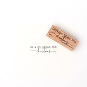 Ein Alexandra Renke Holzstempel und Papier präsentieren "Driving Home for Christmas" in eleganter schwarzer Schrift und fangen die festliche Stimmung perfekt ein.