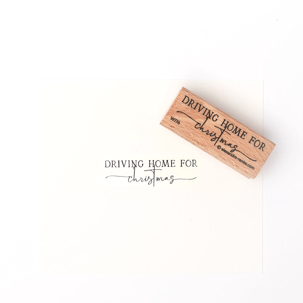 Ein Alexandra Renke Holzstempel und Papier präsentieren "Driving Home for Christmas" in eleganter schwarzer Schrift und fangen die festliche Stimmung perfekt ein.