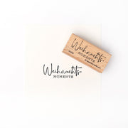 Ein Holzstempel von Alexandra Renke mit dem Schriftzug "Weihnachts MOMENTE" verleiht jedem Papier stilvolle festliche Akzente.