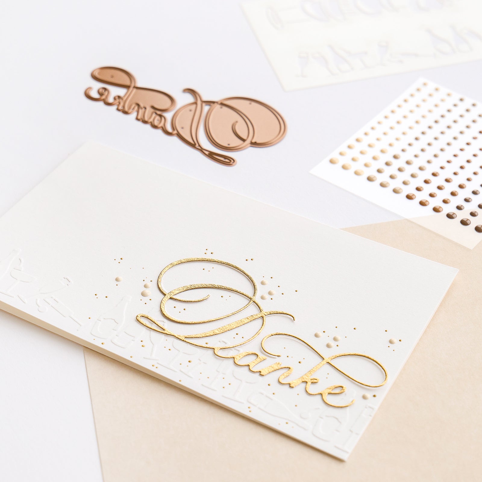 Weiße Danksagungskarte mit goldenem Schriftzug "Kalligrafisch Danke", goldenen Punkten und dekorativen Bastelstickern von Alexandra Renke auf weißem Hintergrund - perfekt zur Kombination mit Ihren Lieblingsdesignpapieren.