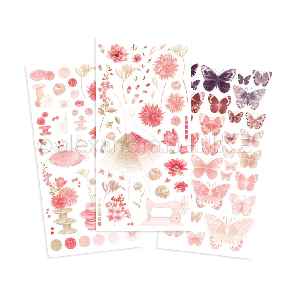 Drei Bögen mit rosa und lila Alexandra Renke Aufklebern mit Blumen, Schmetterlingen, Knöpfen, Faden und einer Nähmaschine - ideal für Bastelprojekte oder in Kombination mit Transferfolien für kreative Bastelarbeiten.