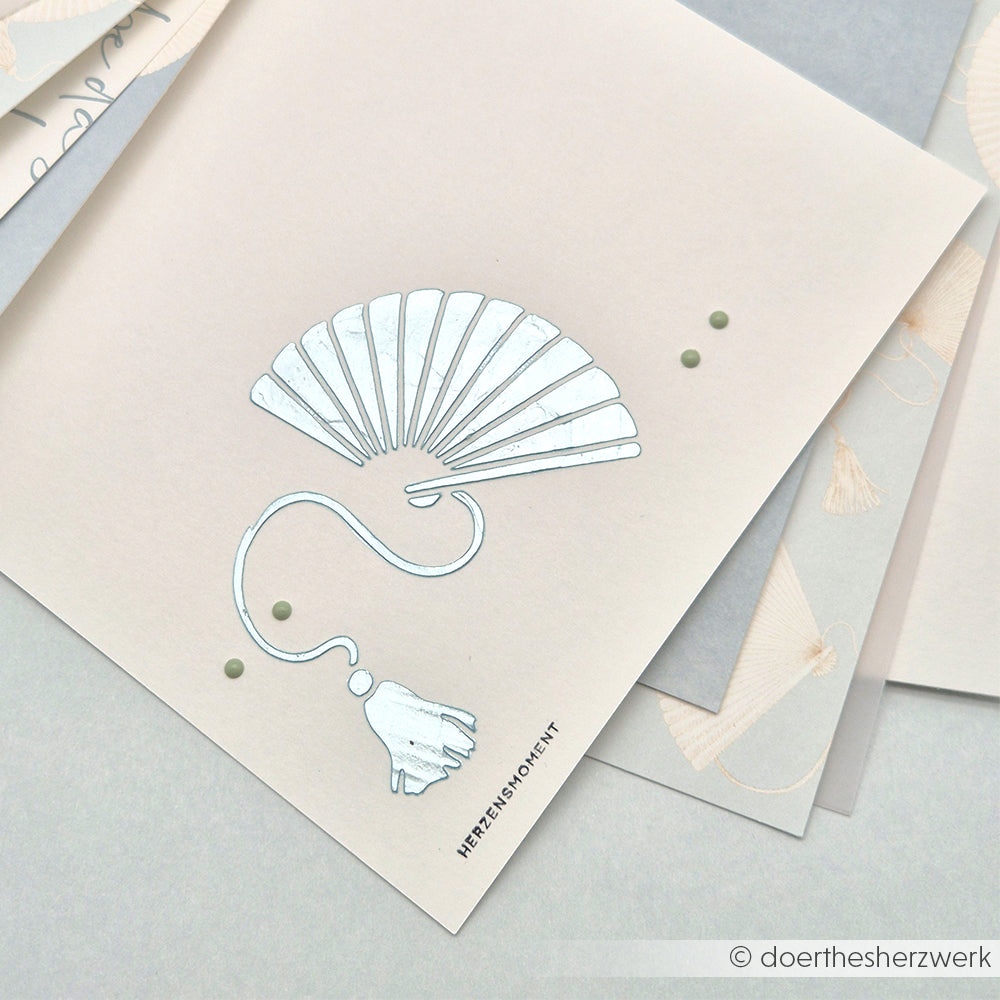 Minimalistische Illustration eines klappbaren Handfächers und einer Quaste auf einer hellen Karte mit grünen Punkten, inspiriert von Alexandra Renke und ideal für Schablone Papierprojekte oder mit wiederverwendbaren Stencils auf neutralen Hintergründen.