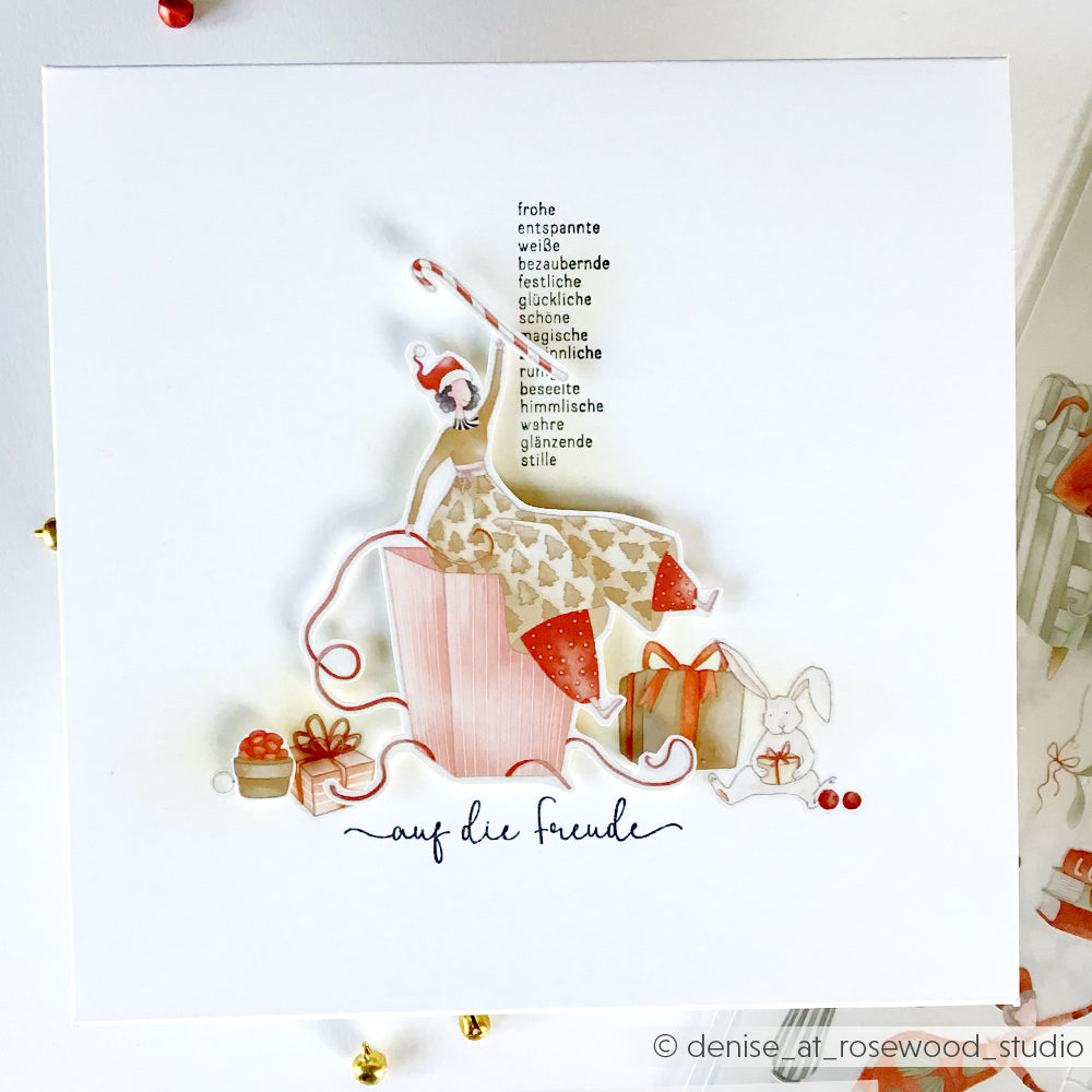 Eine festliche Karte von Alexandra Renke zeigt eine Frau im Schlafanzug mit Geschenken und einem Hasen, unterstrichen von deutschen Worten über Freude und Freundschaft, gestempelt mit lebhaftem Photopolymer für gestochen scharfe Details.