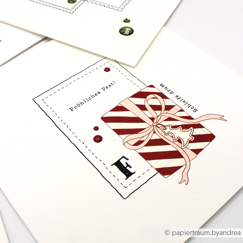 Eine festliche Karte von Alexandra Renke mit einem gestreiften Geschenk mit Schleife und "Fröhliches Fest! Gesellige Stunden" in deutscher Sprache, hergestellt mit Photopolymerstempeln für gestochen scharfe Details.
