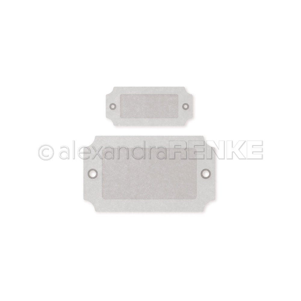 Zwei rechteckige, metallische Anhänger mit abgerundeten Ecken und seitlichen Löchern - ein großer und ein kleiner - eignen sich perfekt, um Projekte mit dem Alexandra Renke Kofferanhänger Set Dies zu verschönern.