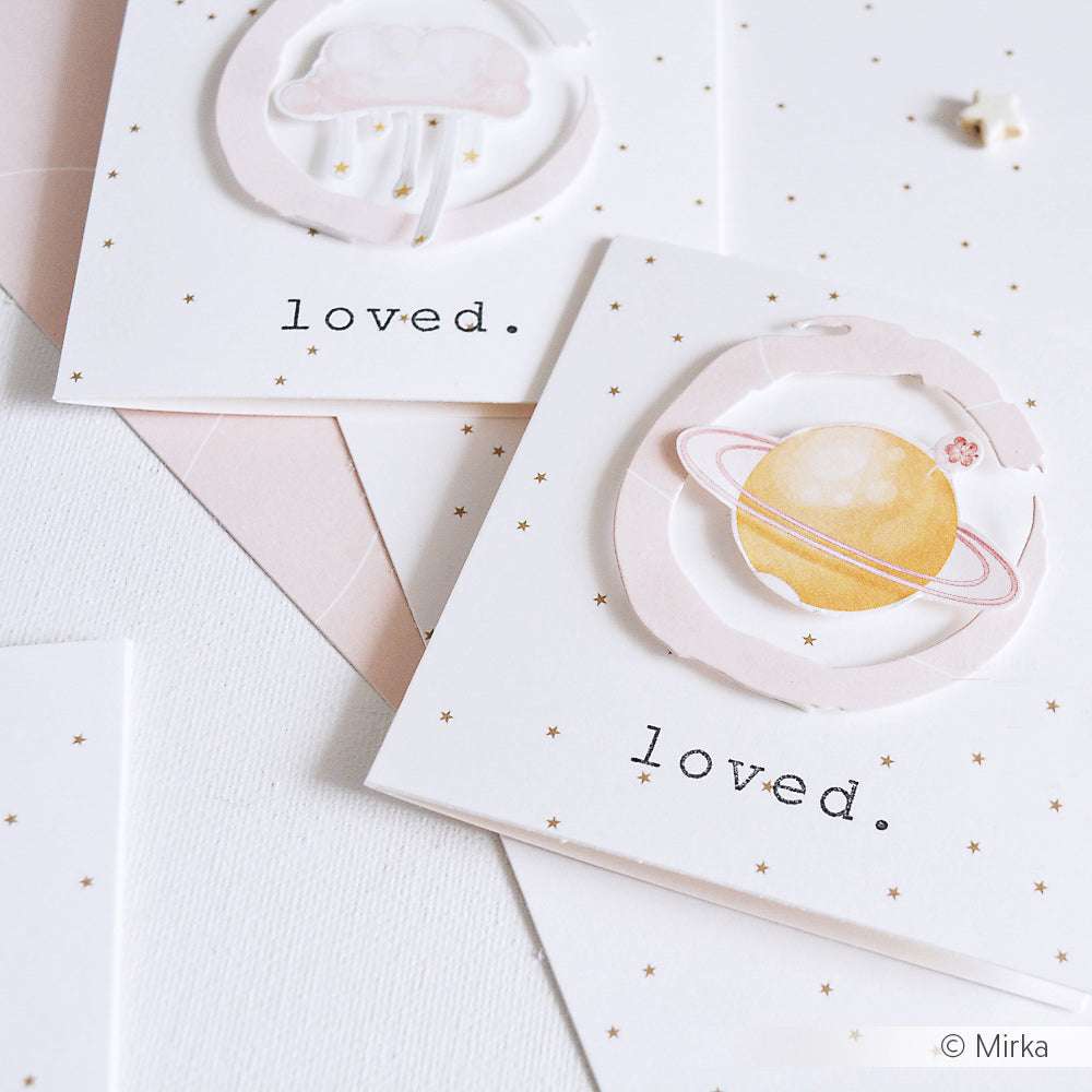 Zwei Karten von Alexandra Renke mit himmlischen Motiven und dem Wort "loved", verziert mit winzigen goldenen Sternen, hergestellt mit hochwertigem Designpapier.
