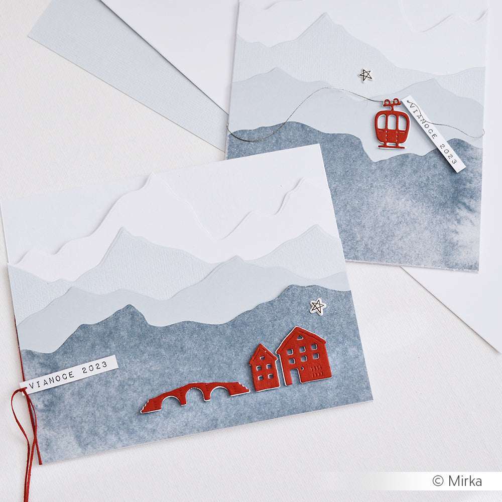 Handgemachte Weihnachtskarten mit Berglandschaft, roten Häusern, einer Brücke und einer roten Seilbahn auf strukturiertem Papier, hergestellt mit der Alexandra Renke Kleine Häuserreihe Stanze für präzise Details.