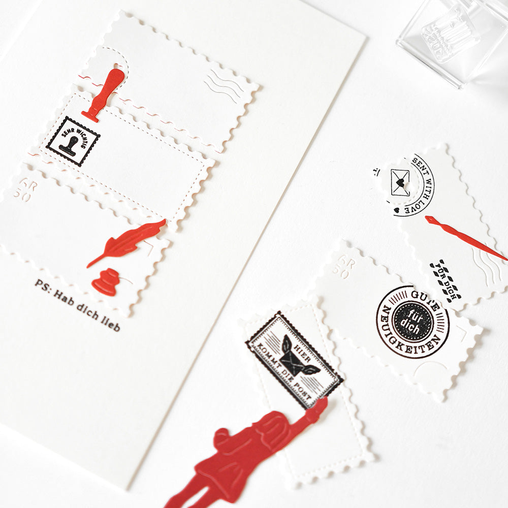 Weißes Briefpapier von Alexandra Renke mit roten und schwarzen Briefmarken, Postformen und Postausschnitten - ideal für kreative Projekte mit Designpapieren oder der Motivstanze Großes Briefmarken Trio.