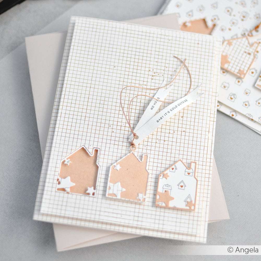 Handgemachte Karte mit drei hausförmigen Ausschnitten aus der Alexandra Renke Motivstanze Haus mit Stern-Rahmen, bunten Designpapieren und einem Anhänger mit der Aufschrift HAVE A GOOD DAY.