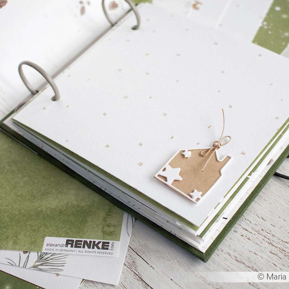 Offenes Scrapbook von Alexandra Renke mit leeren weißen Seiten, gepunkteten Mustern und einem kleinen braunen Sternanhänger - ideal zum Gestalten mit Stanzen aus Stahl oder Ihren bevorzugten DieCut Systemen.