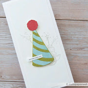 Handgefertigte Karte von Alexandra Renke mit einem grün-blauen Partyhut aus der Motivstanze Großer Partyhut, verziert mit einer roten Bommel, sowie einer dezenten Skizze mit Kuchen und Wunderkerzen - perfekt für festliche Anlässe.